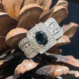 ESTATE 14K WHITE GOLD REGAL RING FEATURING OVAL BLUE SAPPHIRE WITH DIAMOND ACCENTS