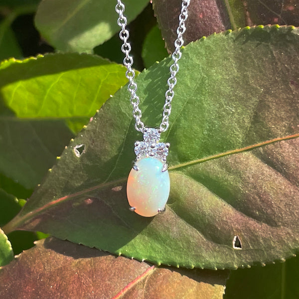 14K White Gold .59ct Oval Opal Pendant with .09ctw Diamond Cluster on 18" Chain